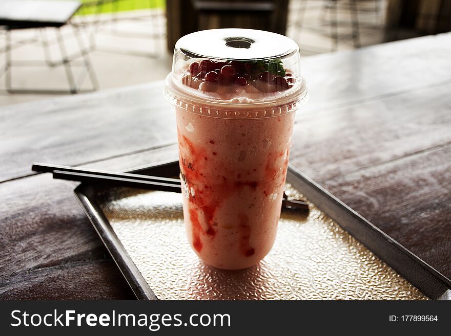 Strawberry yogurt frappe in plastic cup at cafe coffee shop in Ayutthaya, Thailand
