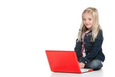 Cute Little Girl Sitting Down And Using A Laptop Stock Photography