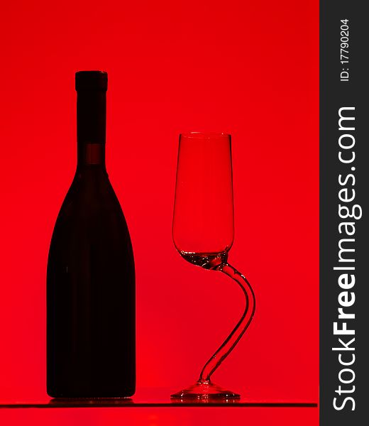 Bottle and glass over red background. Bottle and glass over red background