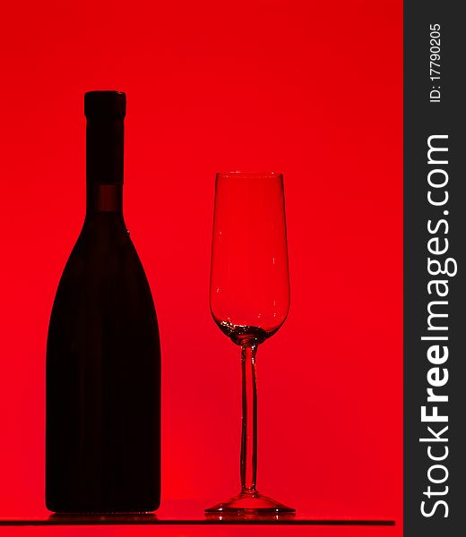 Bottle and glass over red background. Bottle and glass over red background