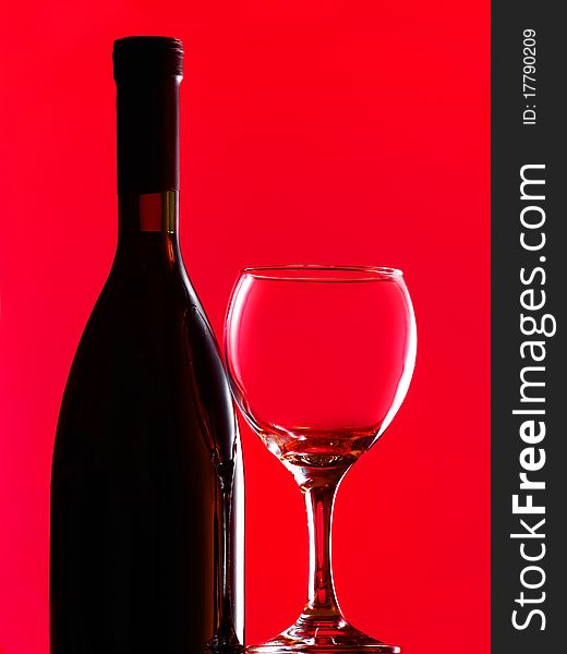 Bottle and glass over red background. Bottle and glass over red background