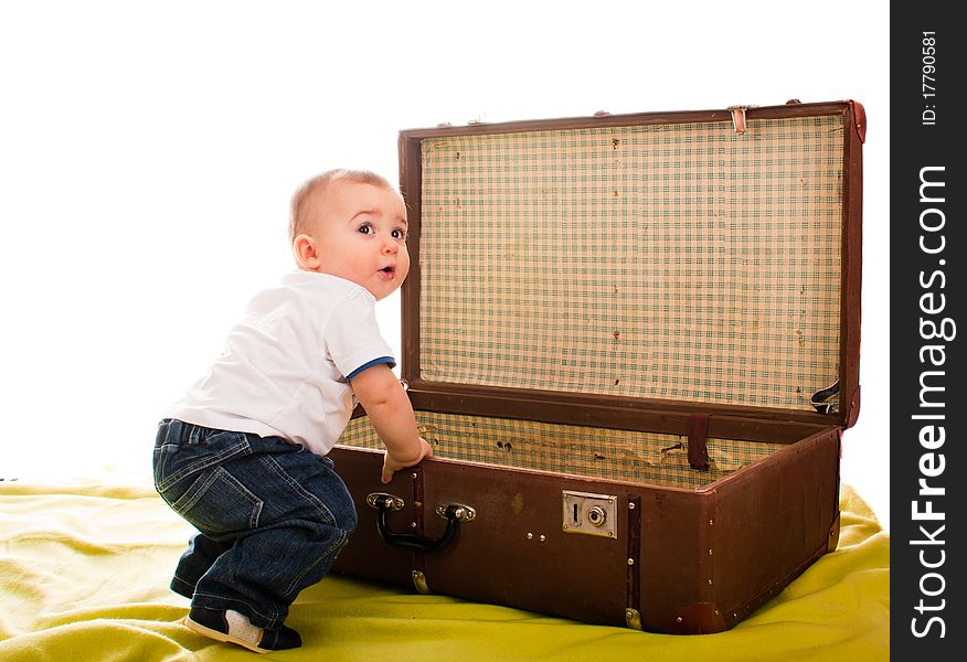 Little boy sitting near an old suitcase. Little boy sitting near an old suitcase