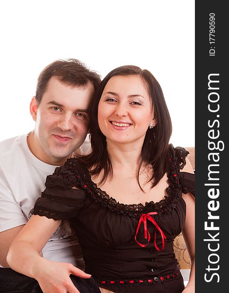 Young charming married couple on a white background