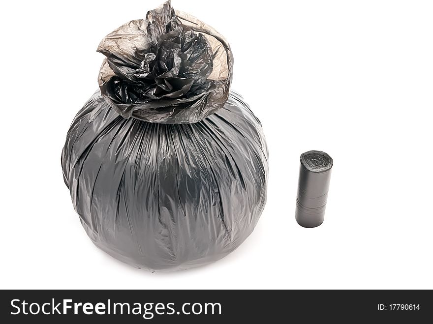 One black garbage bag isolated on white. Soft shadow. One black garbage bag isolated on white. Soft shadow
