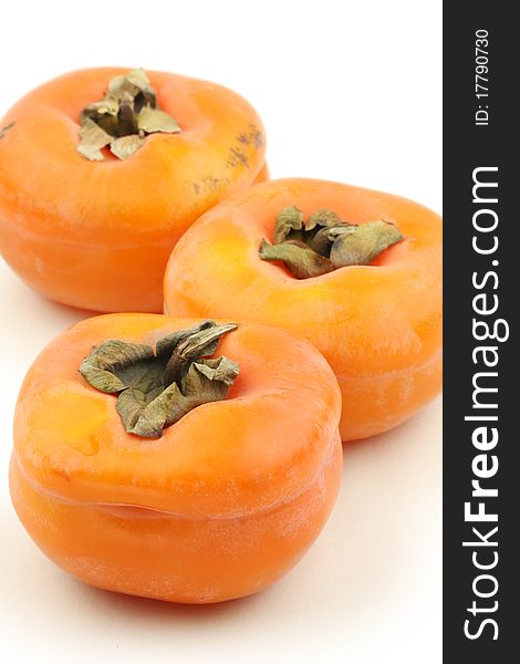 3 Persimmon on a white background close-up lens