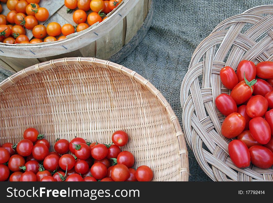 Three varieties of cherry tomatoes for sale at farmers market. Three varieties of cherry tomatoes for sale at farmers market
