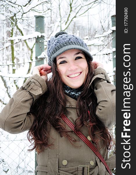 Attractive young girl laughing outside in the winter park. Attractive young girl laughing outside in the winter park