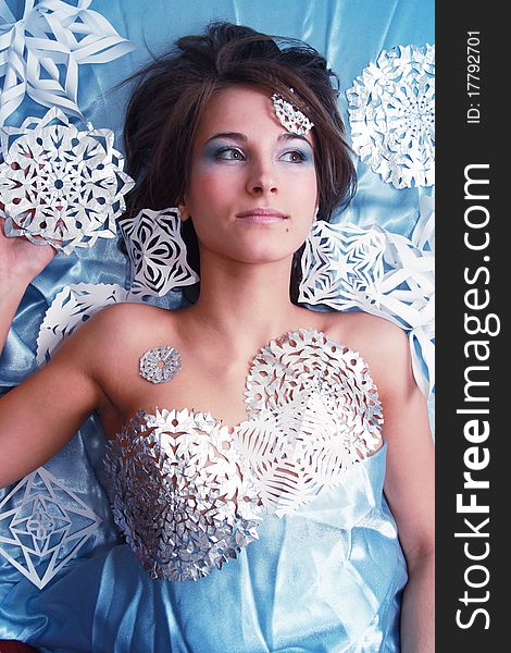 Portrait of young girl with makeup and cut snowflakes. Portrait of young girl with makeup and cut snowflakes