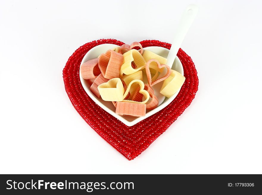 Colored pasta in form of hearts isolated on white