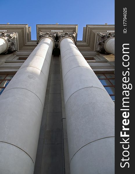 Stalinist architecture. Corinthian capitals and columns. Prospectively on a background of blue sky.