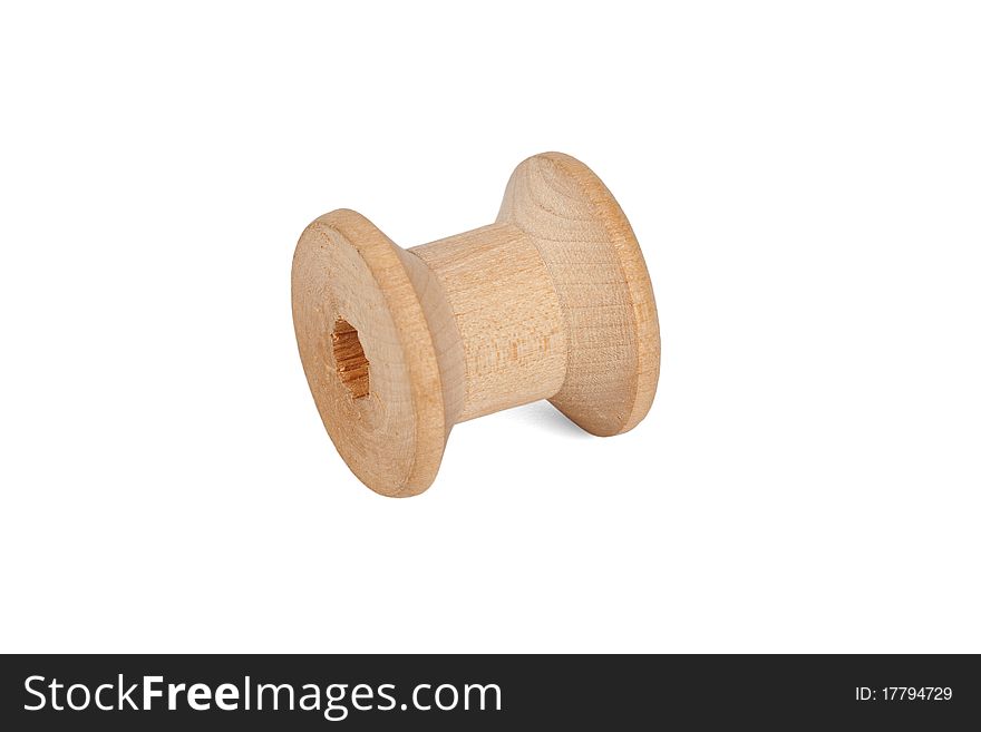 The old, wooden spool from the thread, isolated on a white background. The old, wooden spool from the thread, isolated on a white background