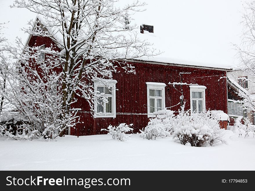 Winter Rural House Under Snowfall