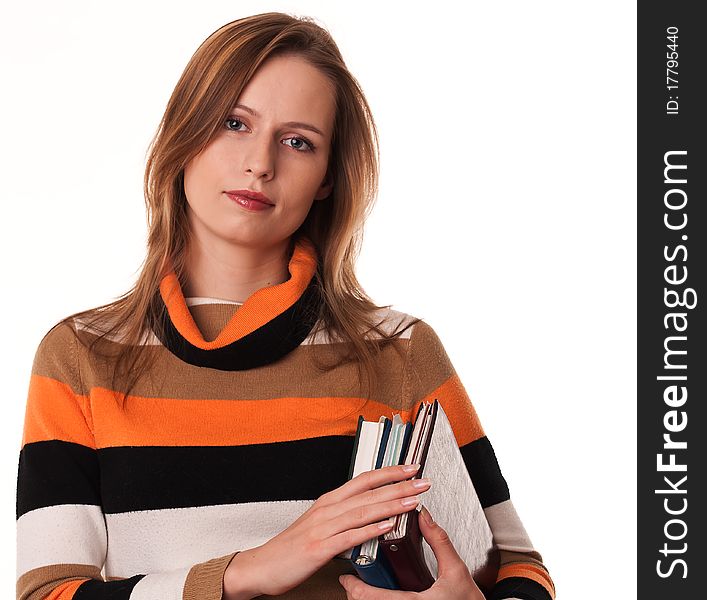 Young woman holding books under her arm on white background