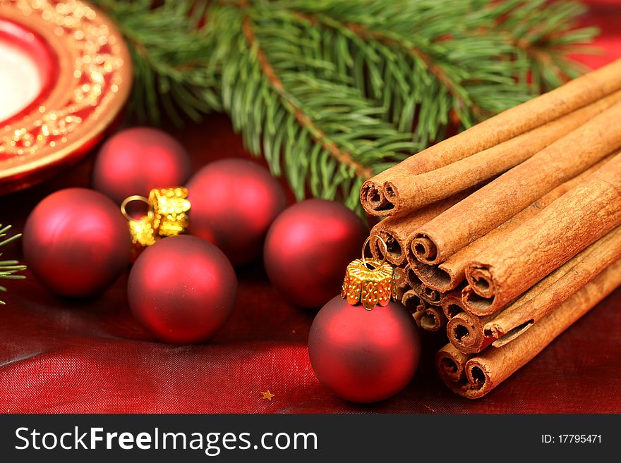 Christmas decorated table - red baubles and aromatic cinnamon. Christmas decorated table - red baubles and aromatic cinnamon