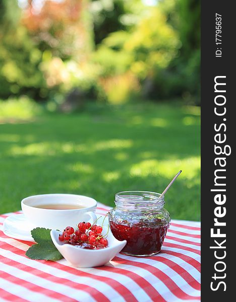 Red currant jam and tea in the garden