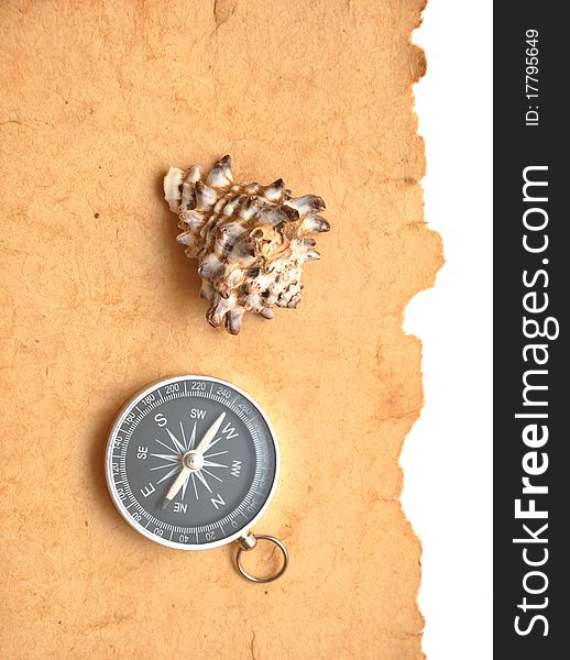 Compass and seashell on old paper