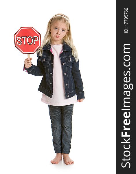 Cute little girl isolated on a white background holding a stop sign, with a sad face. Cute little girl isolated on a white background holding a stop sign, with a sad face
