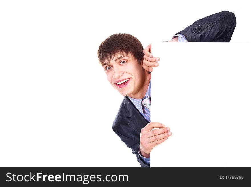 Young excited businessman hiding behind a big blank sheet of paper
