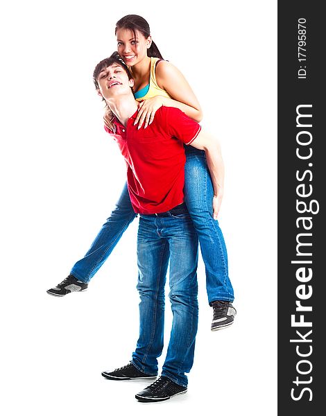 Happy excited teenage couple, a boy giving a piggyback ride to his girlfriend