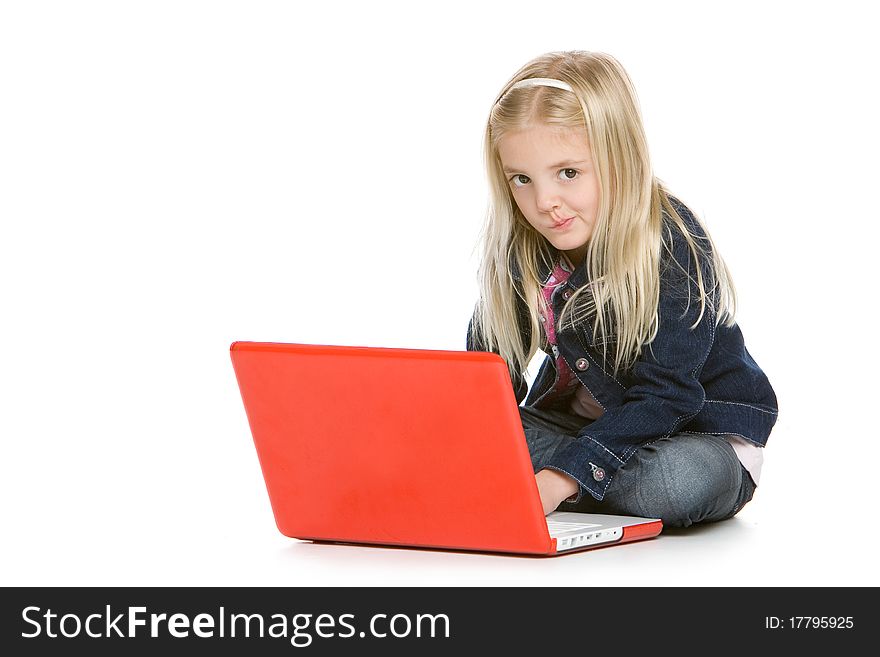 Cute little girl sitting down using laptop. Cute little girl sitting down using laptop