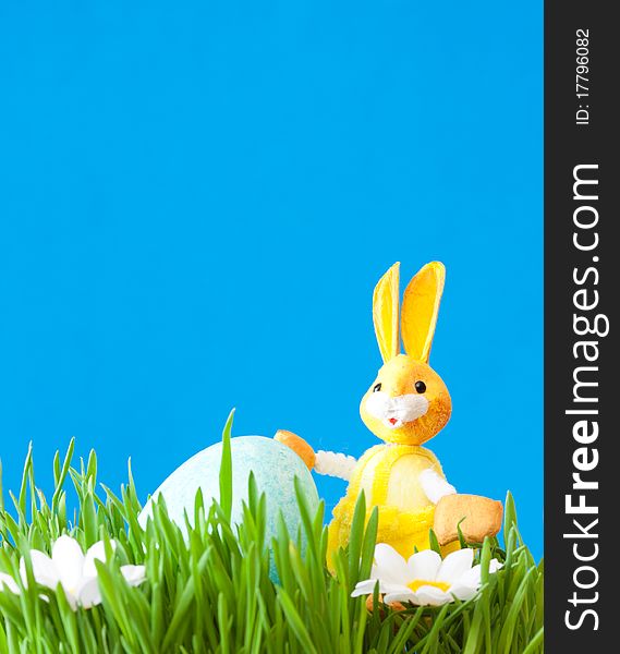 An easter rabbit is in a green grass