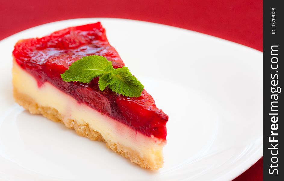 Appetizing piece of strawberry pie with the leaf of mint. Appetizing piece of strawberry pie with the leaf of mint