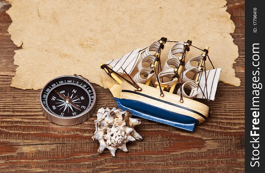 Old paper and model classic boat on wood background