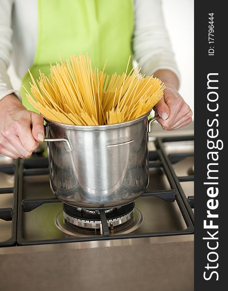 Woman Preparing Spaghetti In Pot