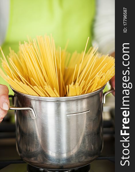 Woman Preparing Spaghetti In Pot