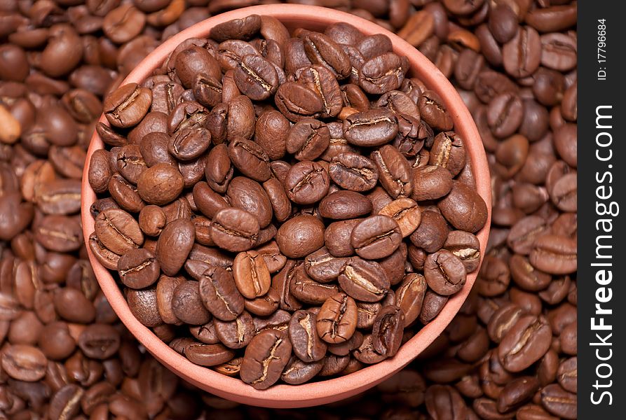 Coffee beans in brown clay pot