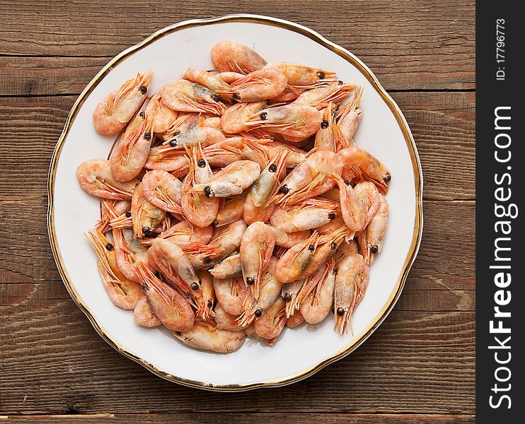 Closeup of plate of shrimp on wood background