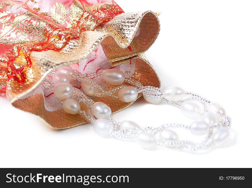 Closeup view of necklace with pearls and gift bag