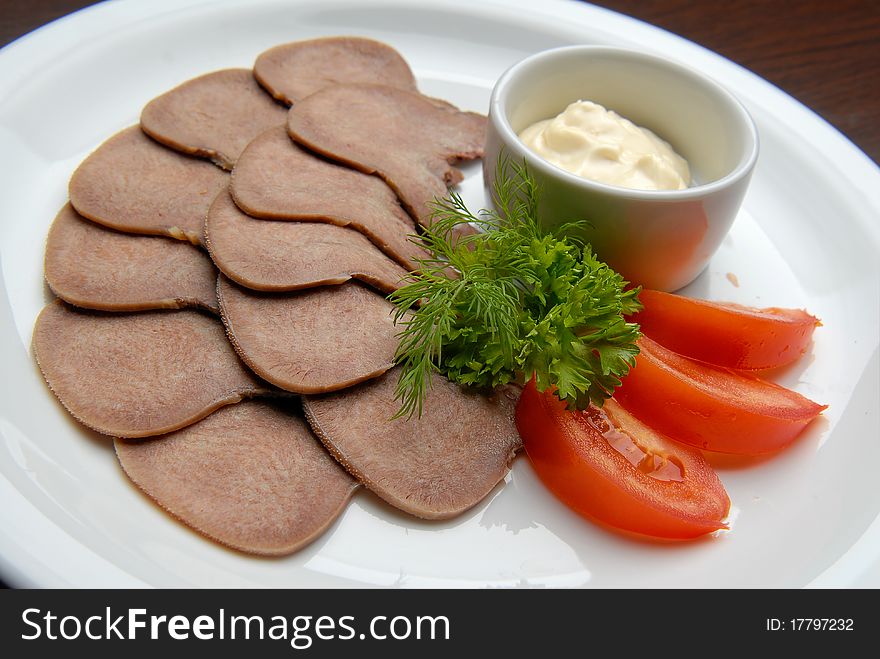 Beef tongue cooked with vegetables and sauce. Beef tongue cooked with vegetables and sauce