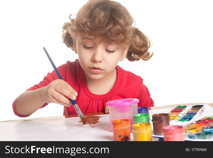 Little girl draws a colored paint