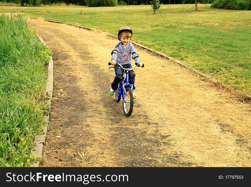 a little girl rides a bike in the park