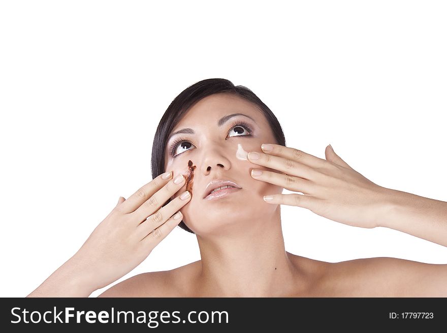 Portrait of a girl with chocolate on his face, white background. Brunette. Portrait of a girl with chocolate on his face, white background. Brunette