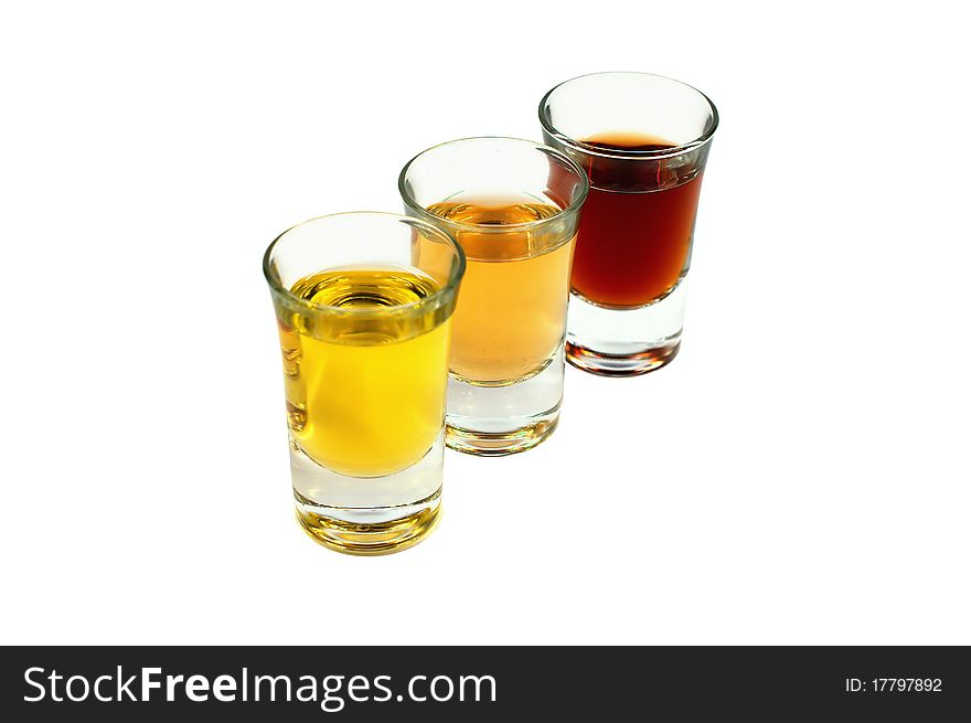 Three glasses with several liquids. First - olive oil, second - whiskey, third - brandy