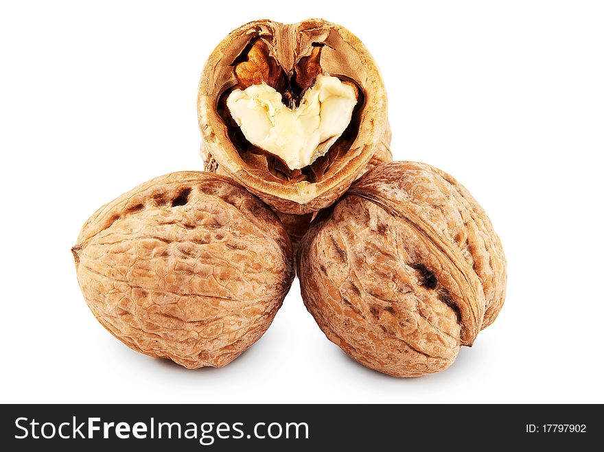 Two whole and chopped walnuts isolated on a white background