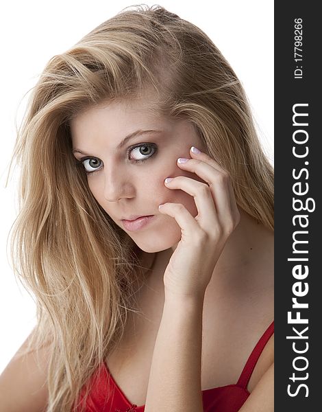 Intense close-up of pretty teenage girl with big eyes and beautiful hair in a red dress. Intense close-up of pretty teenage girl with big eyes and beautiful hair in a red dress