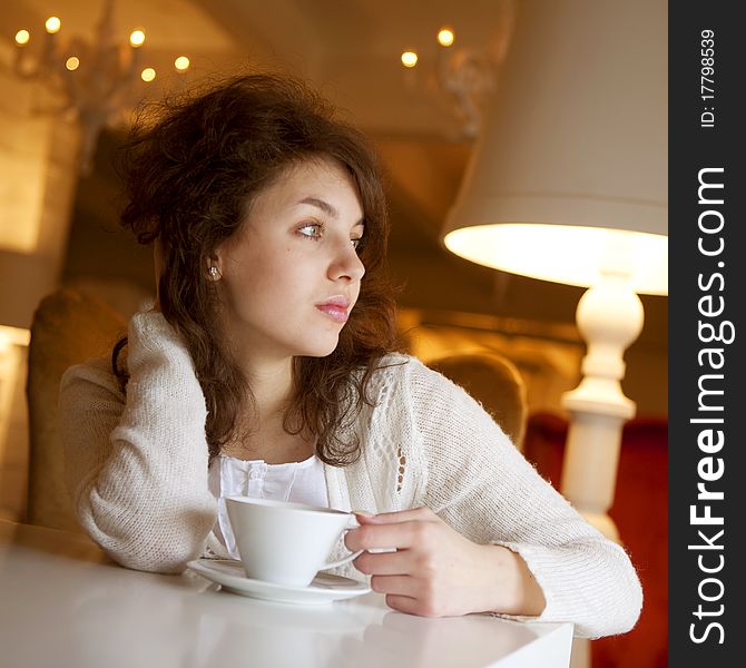 Young Woman Enjoying Latte Coffee In Cafe