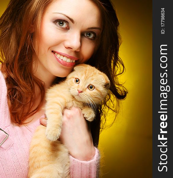 Young woman with red England lop-eared kitten