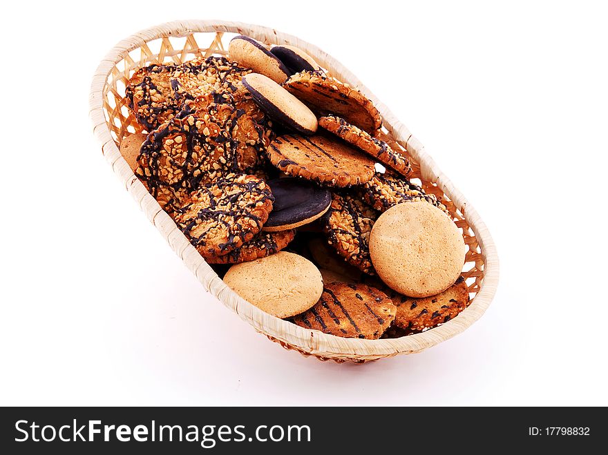 Biscuit in the basket with nuts and chocolate isolated on white background