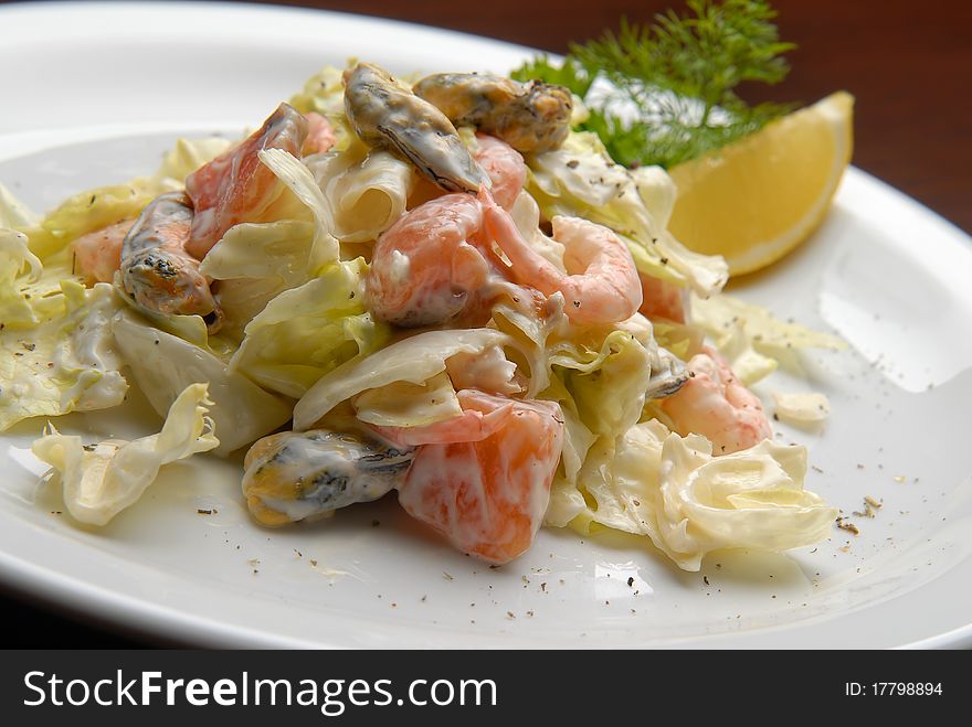 salad with fresh cabbage, seafood, mayonnaise and lemon