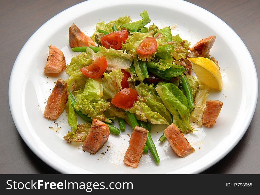 Salad with fresh vegetables, grilled salmon and asparagus