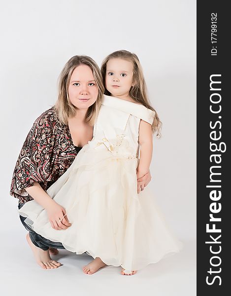 Beautiful young mother and her three year old daughter at studio. Beautiful young mother and her three year old daughter at studio