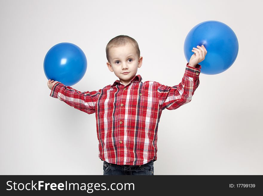 Portrait Of Cute Boy With Blue Balloons