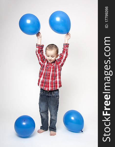Portrait of cute boy with blue balloons