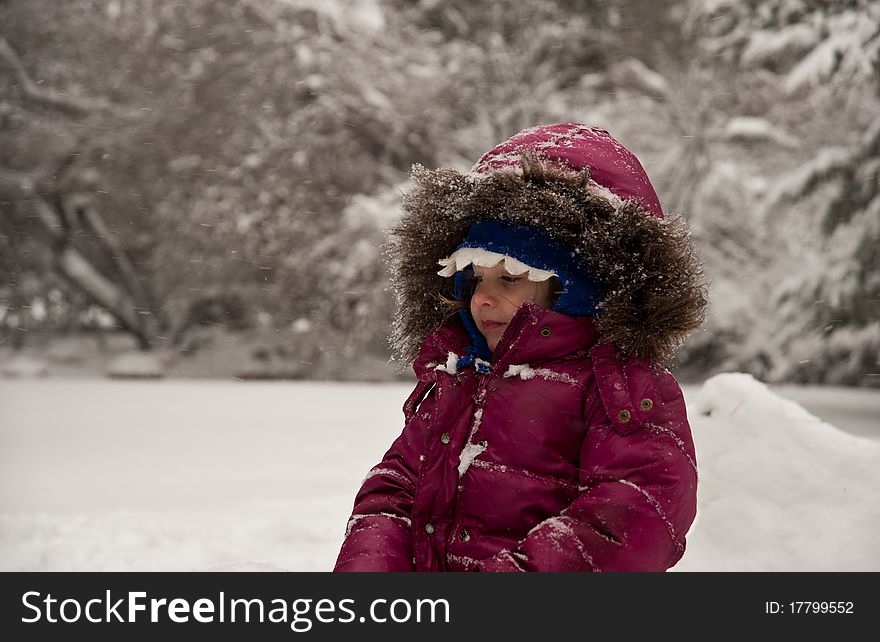 Little Girl Sitting In The Snow. Little Girl Sitting In The Snow