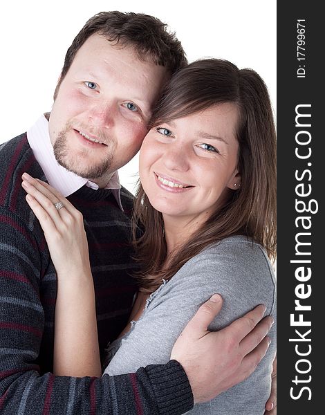 Portrait of a beautiful young couple hugging each other against white background