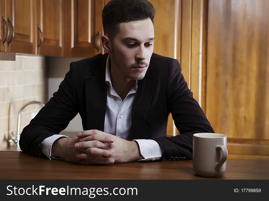 Man Sitting At The Kitchen Counter